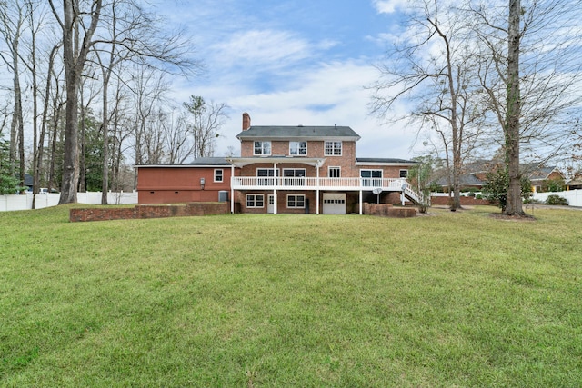 1560 NW Lee Blvd, Orangeburg, SC 29118 - rear view of property featuring a lawn, a deck, fence, brick siding, and a chimney