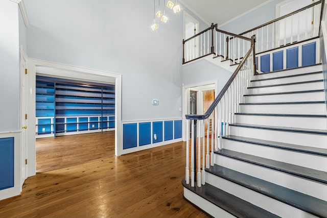 1560 NW Lee Blvd, Orangeburg, SC 29118 - stairs with a high ceiling, wood-type flooring, and ornamental molding