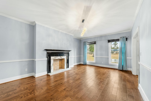 1560 NW Lee Blvd, Orangeburg, SC 29118 - unfurnished living room featuring baseboards, a fireplace with raised hearth, wood finished floors, and ornamental molding