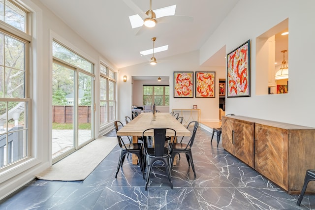 dining room featuring lofted ceiling with skylight