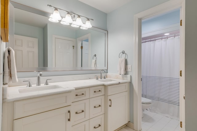 bathroom with toilet, vanity, and a shower with shower curtain