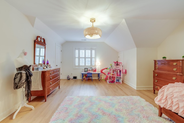 bedroom with multiple windows, lofted ceiling, and light hardwood / wood-style flooring