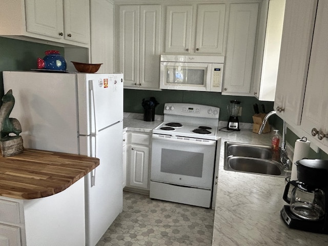 1736 E Ashley Ave, Folly Beach, SC 29439 - kitchen with white appliances, a sink, white cabinetry, and light countertops