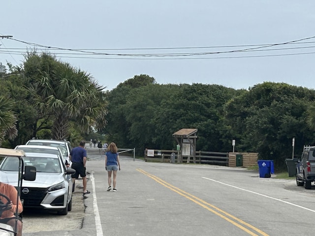 1736 E Ashley Ave, Folly Beach, SC 29439 - view of asphalt road featuring a forest view