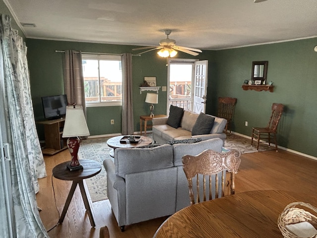 1736 E Ashley Ave, Folly Beach, SC 29439 - living area with wood finished floors, ceiling fan, crown molding, and baseboards