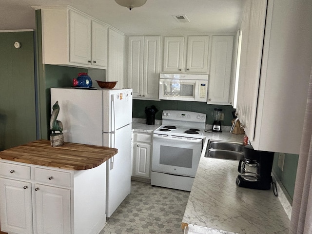 1736 E Ashley Ave, Folly Beach, SC 29439 - kitchen featuring white appliances, white cabinetry, light flooring, and light countertops