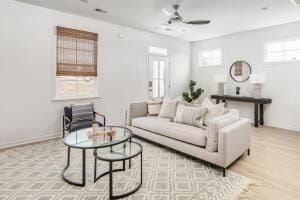 living room featuring ceiling fan and a healthy amount of sunlight