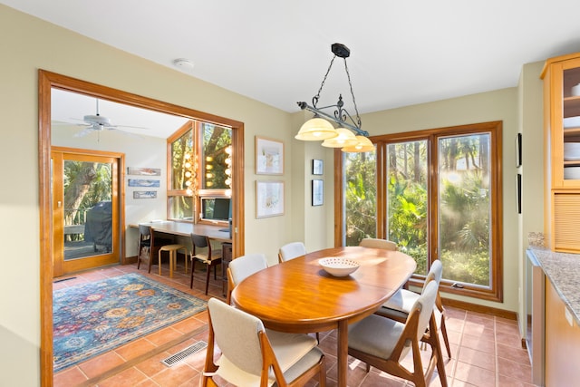 dining area with ceiling fan and light tile patterned flooring