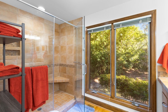 bathroom featuring hardwood / wood-style flooring and an enclosed shower