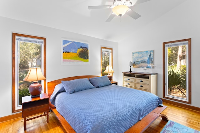 bedroom with multiple windows, ceiling fan, and light wood-type flooring