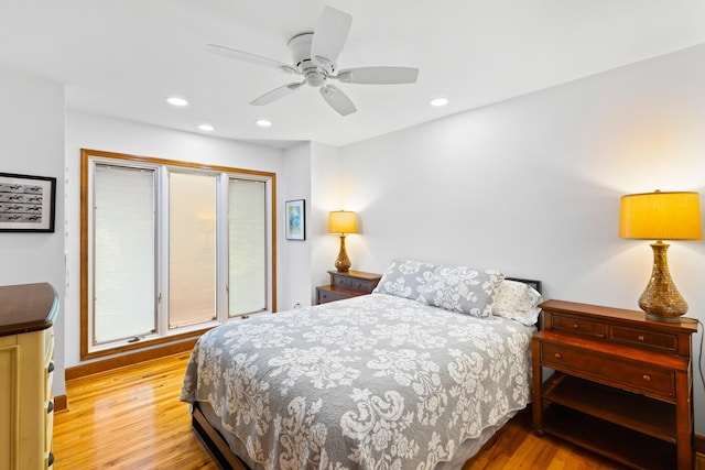 bedroom with ceiling fan and light wood-type flooring