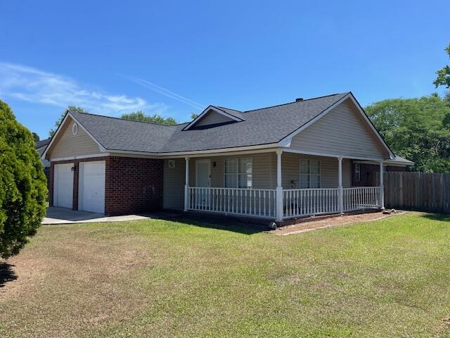 7733 Buck Pond Rd, North Charleston, SC 29418 - view of front of property featuring a porch, a garage, concrete driveway, and roof with shingles