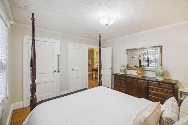 647 Ellis St, Mount Pleasant, SC 29464 - bedroom with ornamental molding, wood finished floors, multiple windows, baseboards, and a textured ceiling