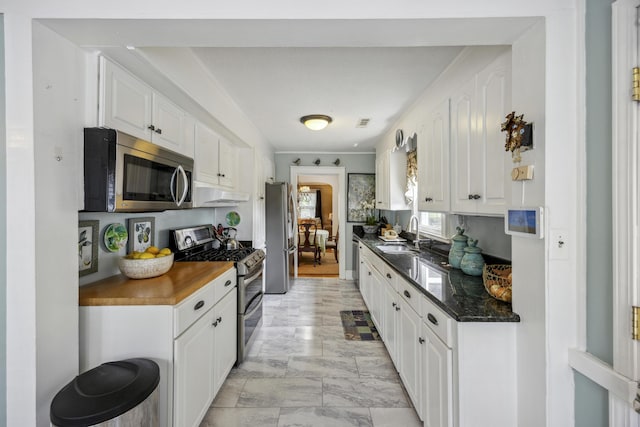 647 Ellis St, Mount Pleasant, SC 29464 - kitchen with appliances with stainless steel finishes, under cabinet range hood, white cabinets, and a sink