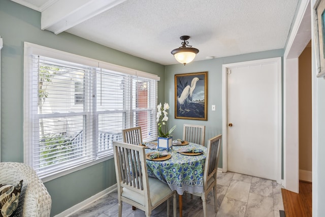 647 Ellis St, Mount Pleasant, SC 29464 - dining area with baseboards, light marble finish floors, beamed ceiling, and a textured ceiling