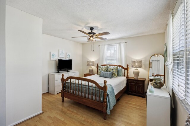 647 Ellis St, Mount Pleasant, SC 29464 - bedroom with light wood finished floors, a textured ceiling, a ceiling fan, and baseboards