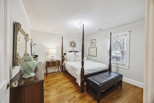 647 Ellis St, Mount Pleasant, SC 29464 - bedroom featuring light wood-style floors, a textured ceiling, baseboards, and crown molding