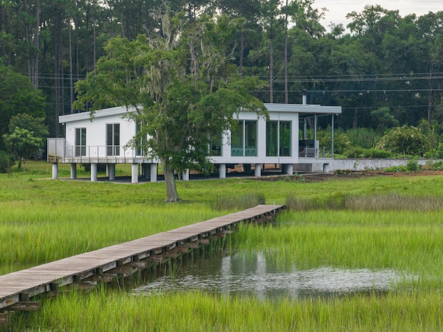 dock area featuring a lawn and a water view