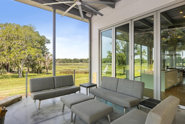 sunroom / solarium featuring a rural view and beam ceiling