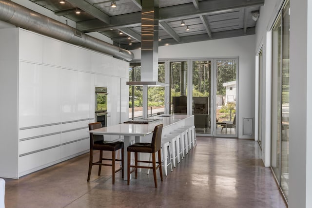 sunroom / solarium featuring beamed ceiling