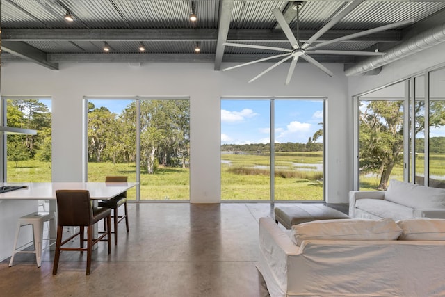 sunroom with a wealth of natural light, ceiling fan, and beam ceiling