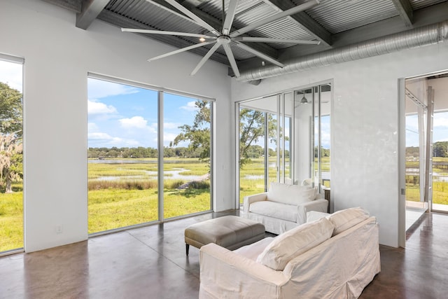 sunroom with beamed ceiling and ceiling fan