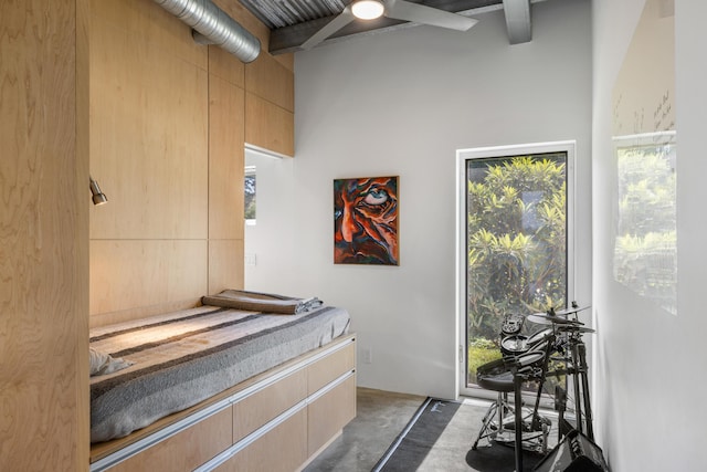 miscellaneous room featuring a towering ceiling and beam ceiling