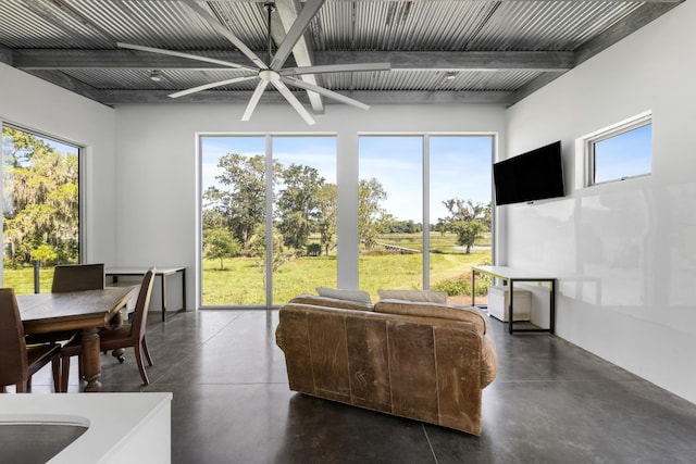 living room with ceiling fan and beam ceiling