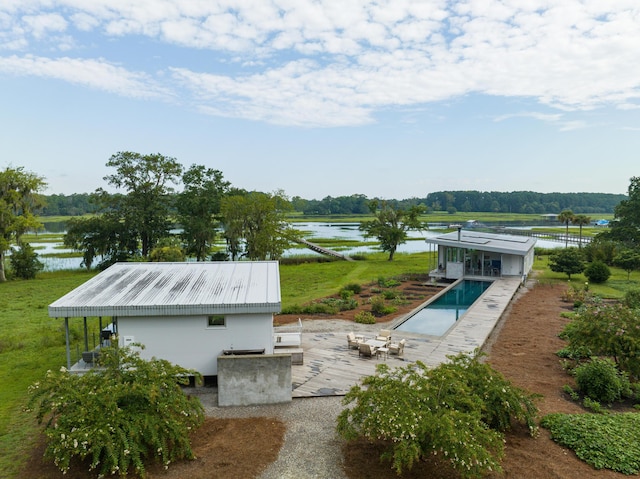 view of swimming pool with a water view and a patio