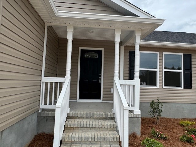 view of exterior entry featuring a porch