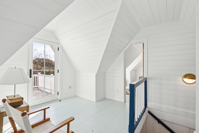 interior space featuring wood walls and vaulted ceiling