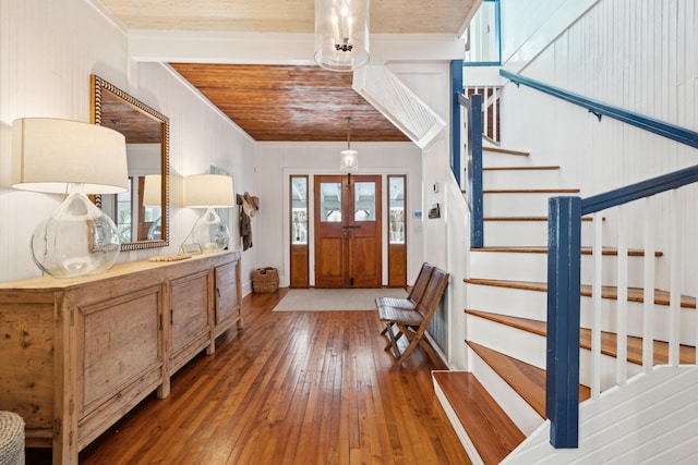 foyer entrance featuring dark wood-type flooring, beam ceiling, and wood ceiling