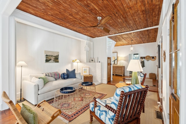 living room featuring ceiling fan, light hardwood / wood-style flooring, ornamental molding, and wood ceiling