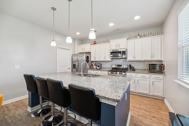 9711 Fanning Basket Ln, Ladson, SC 29456 - kitchen featuring appliances with stainless steel finishes, a sink, a center island with sink, white cabinetry, and recessed lighting
