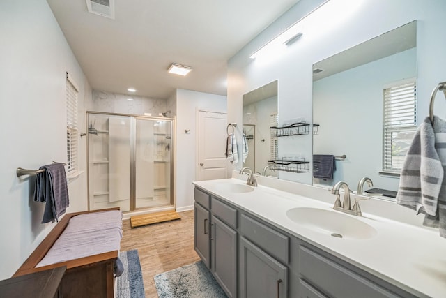 9711 Fanning Basket Ln, Ladson, SC 29456 - bathroom with a stall shower, double vanity, and wood finished floors
