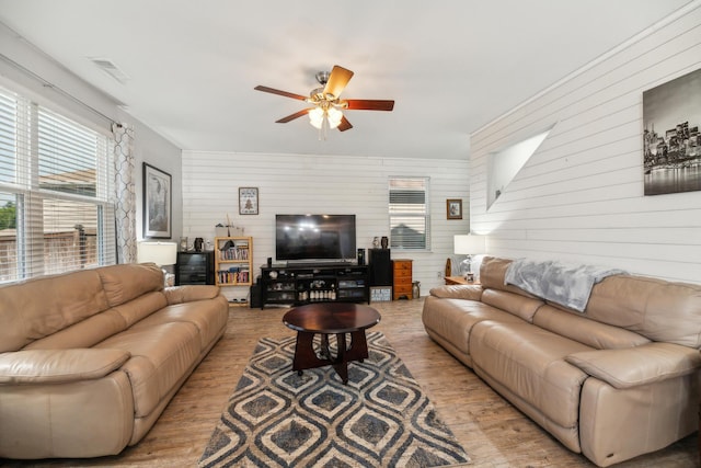 9711 Fanning Basket Ln, Ladson, SC 29456 - living area with ceiling fan, wood finished floors, healthy amount of natural light, and wood walls