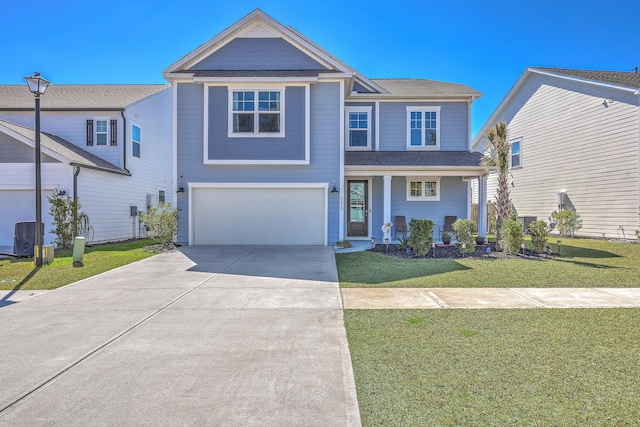 view of front facade featuring a front yard, driveway, and an attached garage