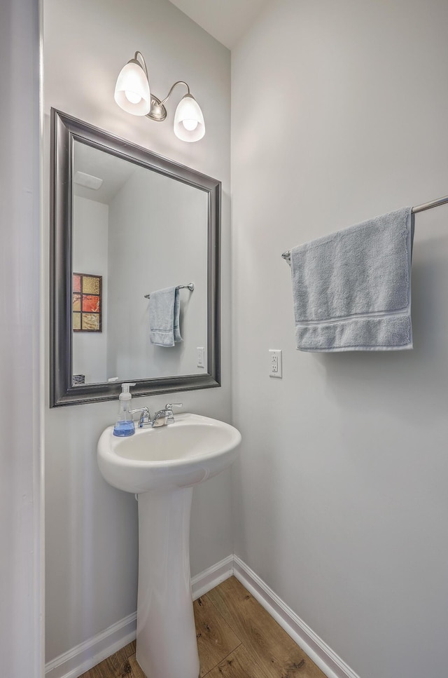 bathroom with baseboards and wood finished floors