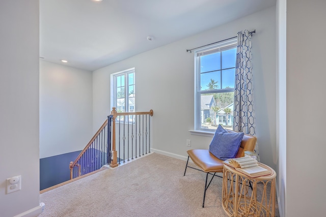 living area featuring carpet, baseboards, an upstairs landing, and recessed lighting