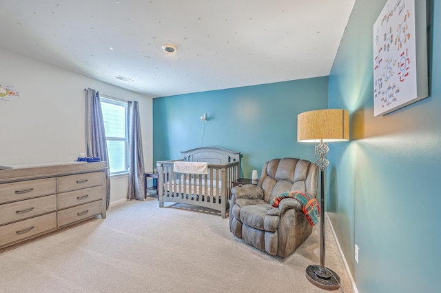 bedroom featuring baseboards, visible vents, and light colored carpet