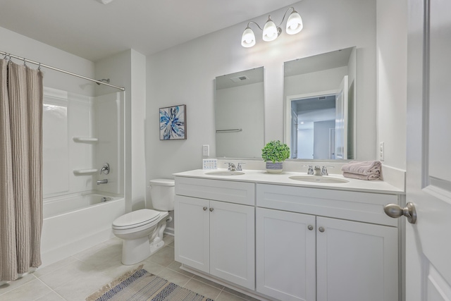 full bath with double vanity, a sink, toilet, and tile patterned floors