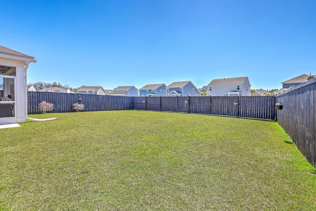 view of yard featuring a residential view and a fenced backyard