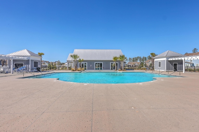 pool with a patio area, fence, and a pergola