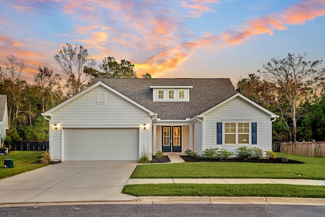 view of front of house with a lawn and a garage