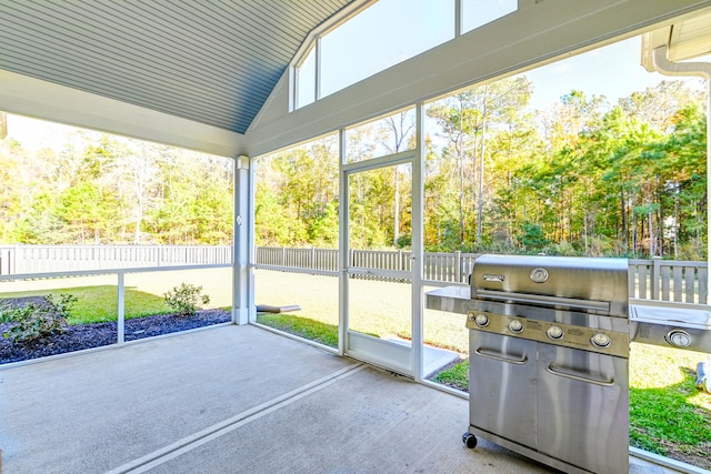 unfurnished sunroom with vaulted ceiling and wood ceiling