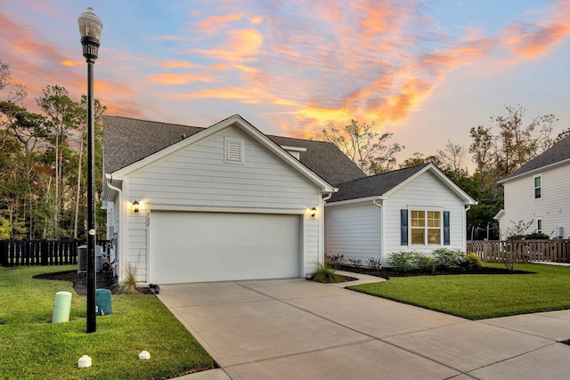 view of front of home with a yard and a garage