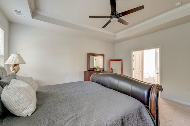 carpeted bedroom featuring a tray ceiling, ceiling fan, and crown molding