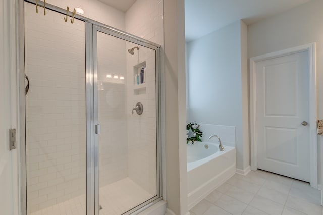 bathroom featuring tile patterned flooring and separate shower and tub