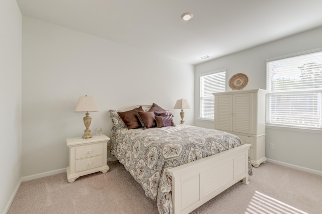 bedroom featuring light colored carpet