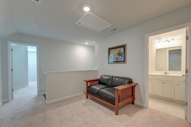 living area featuring light colored carpet and vaulted ceiling